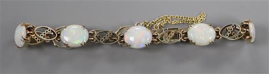 A 9ct gold and white opal set bracelet (one stone a.f).